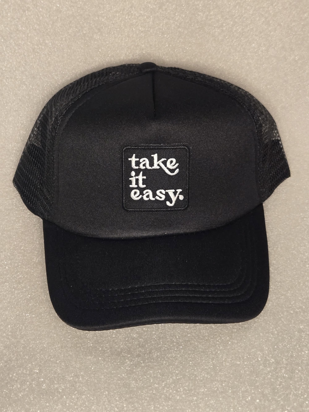 Unisex Black 'take it easy.' Trucker Hat